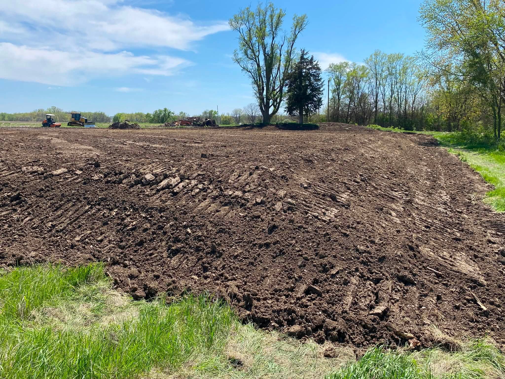 Recently graded site with construction equipment in the Des Moines area